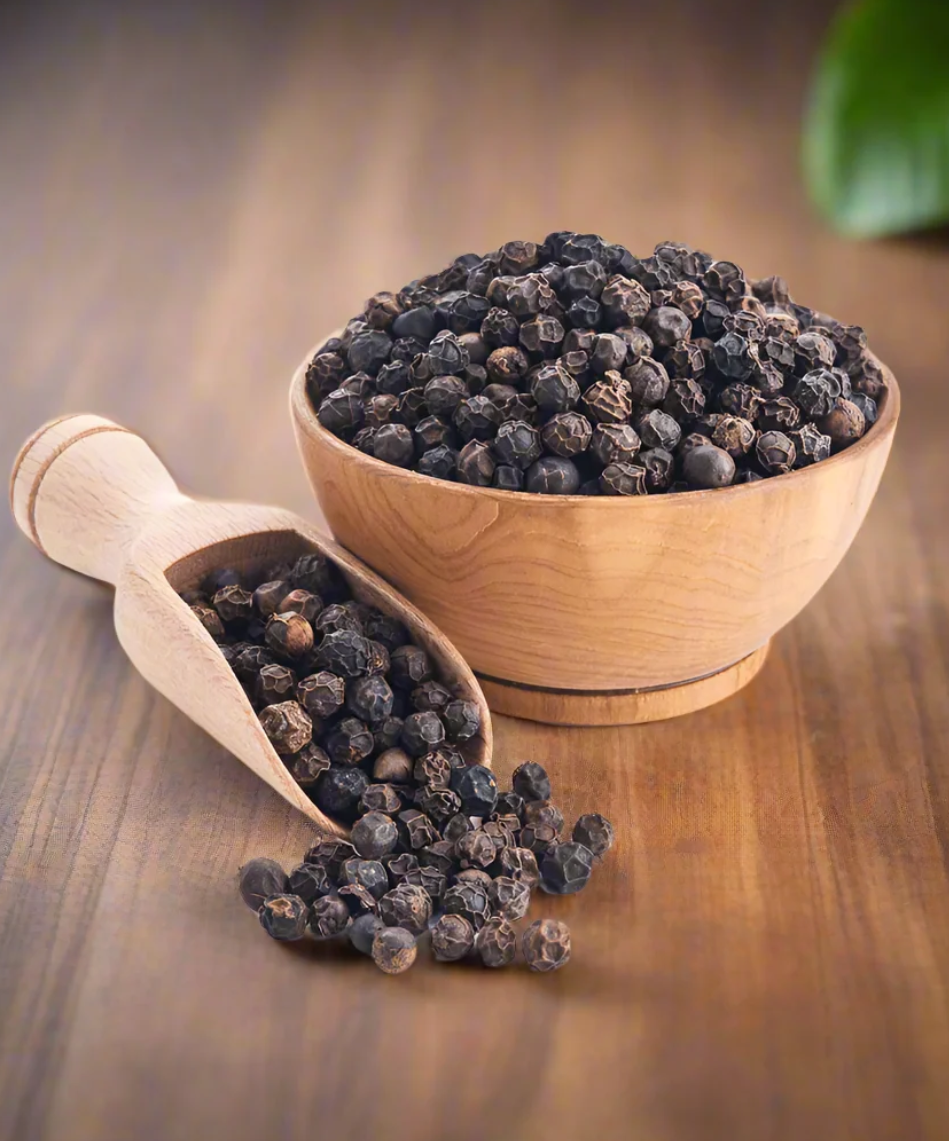 Black peppercorns in a wooden bowl